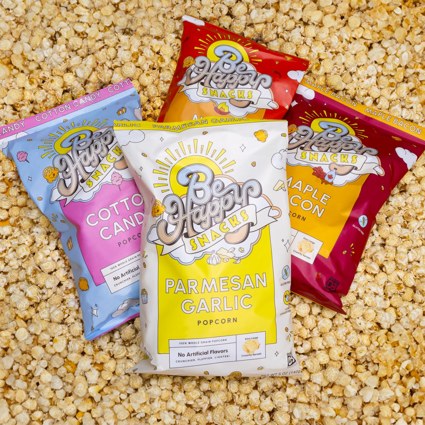 Be Happy Snacks popcorn bags: Cotton Candy, Parmesan Garlic, Maple Bacon, and White Cheddar